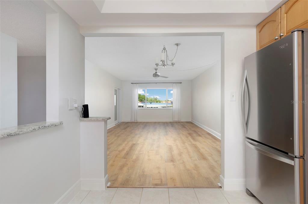 4725 Cove Circle, Unit 207 St. Petersburg, FL 33708 - Photo 5 of 46 a view of an empty room with a kitchen