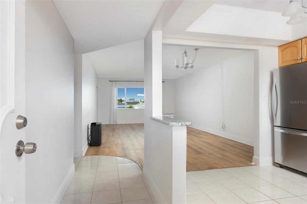 4725 Cove Circle, Unit 207 St. Petersburg, FL 33708 - Photo 6 of 46 a view of kitchen with furniture and refrigerator