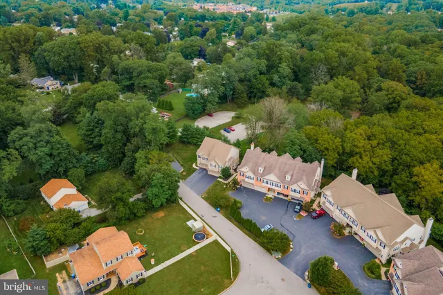 an aerial view of a house with a yard and lake