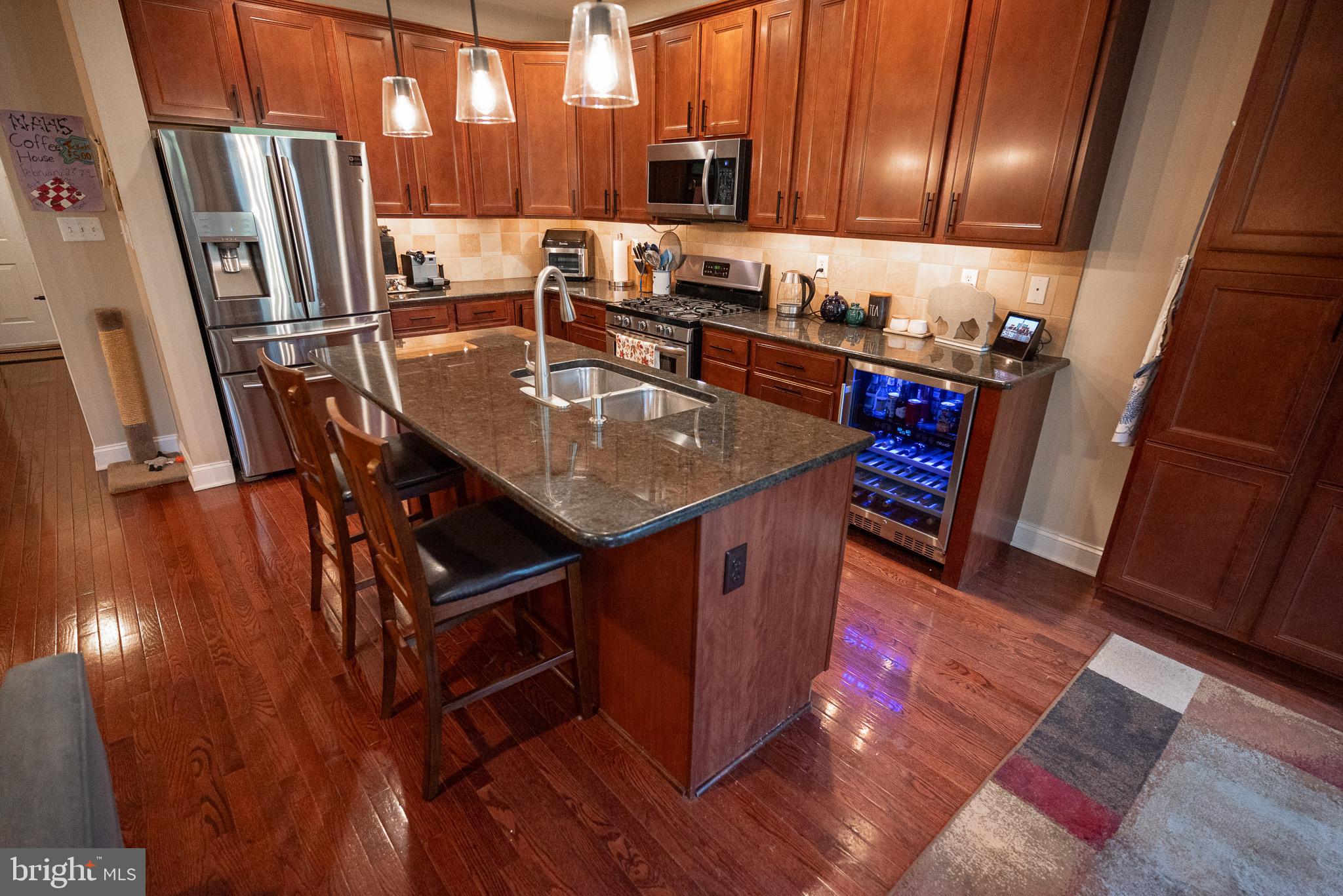 210 Spring Lane West Chester, PA 19382 - Photo 11 of 49 a kitchen with stainless steel appliances granite countertop a sink stove and refrigerator