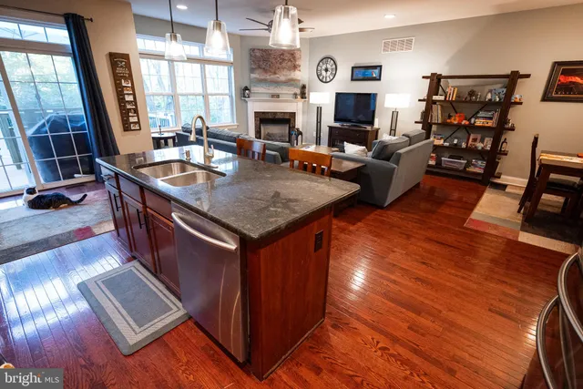 a kitchen with sink cabinets and wooden floor