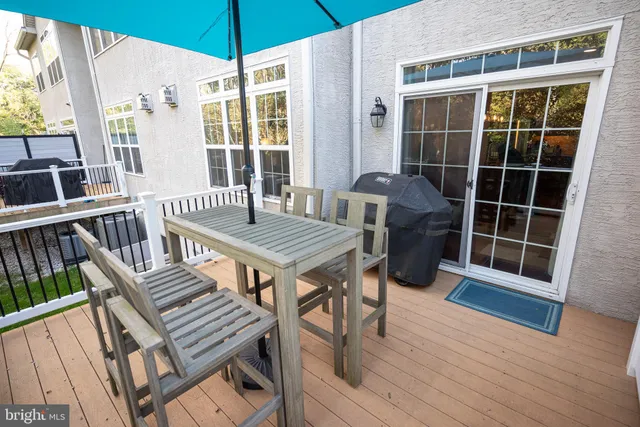 a view of balcony with wooden floor and outdoor seating