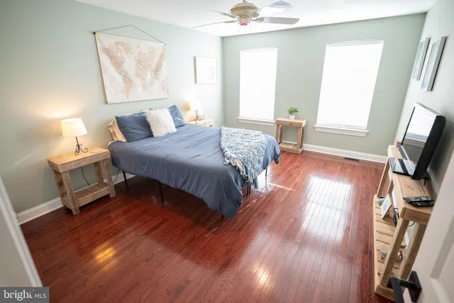 a bedroom with a bed and a potted plant