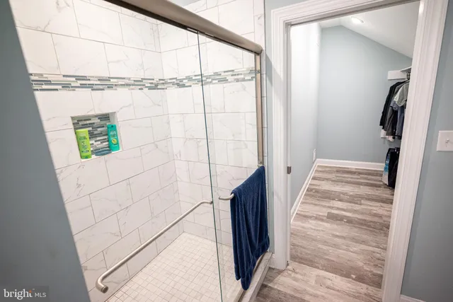 a view of walk in closet with clothes