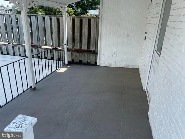 a view of a room with wooden floor and a window