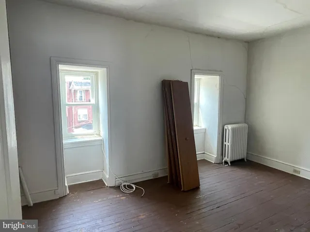 a view of a kitchen with furniture and a potted plant