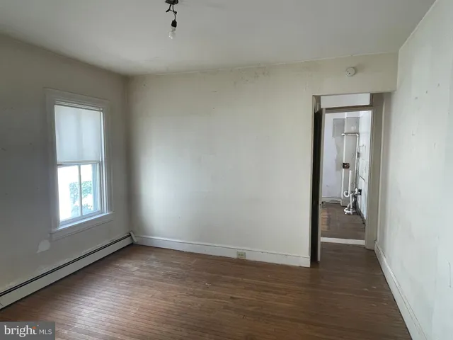 a room with a refrigerator and a window