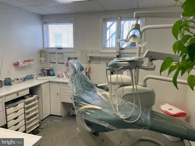 a kitchen with a refrigerator sink and cabinets