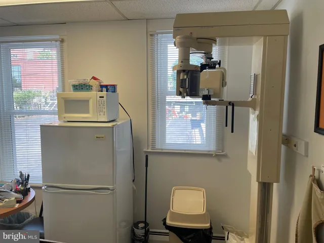 a bathroom with a toilet and a shower curtain