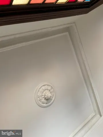 a living room with furniture a flat screen tv and a window