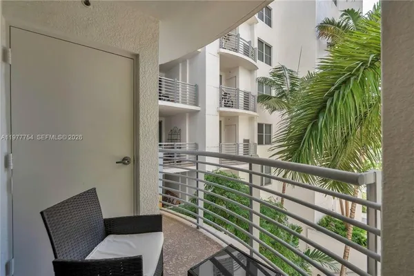 a view of balcony with two chairs and a potted plant