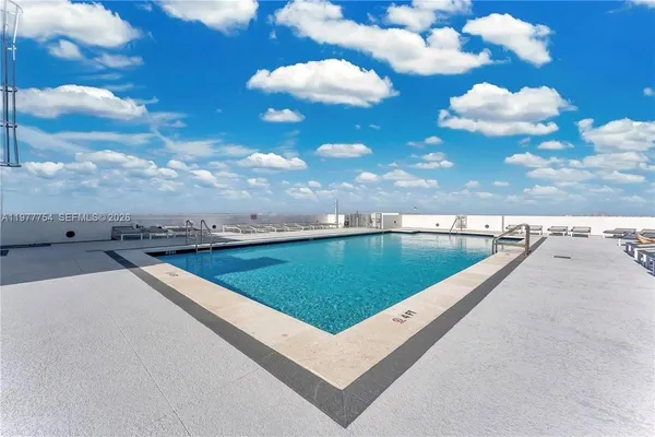 a view of a swimming pool with an outdoor seating