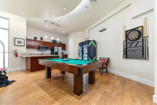 a room with stainless steel appliances kitchen island granite countertop furniture and a kitchen view