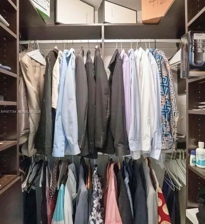 a view of walk in closet with clothes