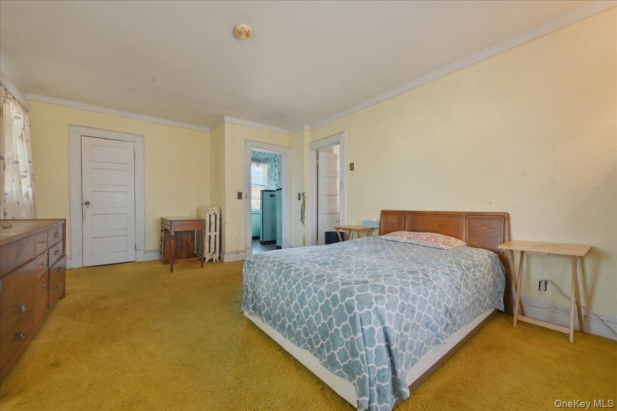 590 Waterview Road Oceanside, NY 11572 - Photo 13 of 26 a bedroom with a bed and table