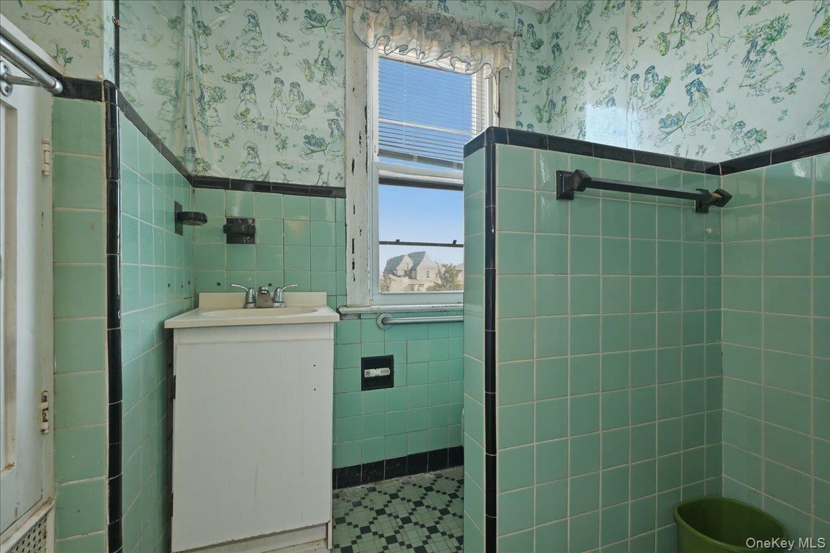 590 Waterview Road Oceanside, NY 11572 - Photo 14 of 26 a bathroom with a sink toilet and shower