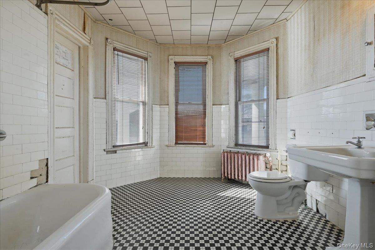 590 Waterview Road Oceanside, NY 11572 - Photo 16 of 26 a bathroom with a sink a toilet and shower
