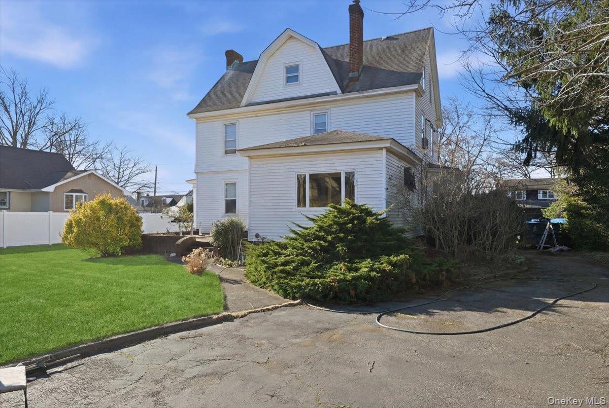 590 Waterview Road Oceanside, NY 11572 - Photo 25 of 26 a front view of a house with a yard