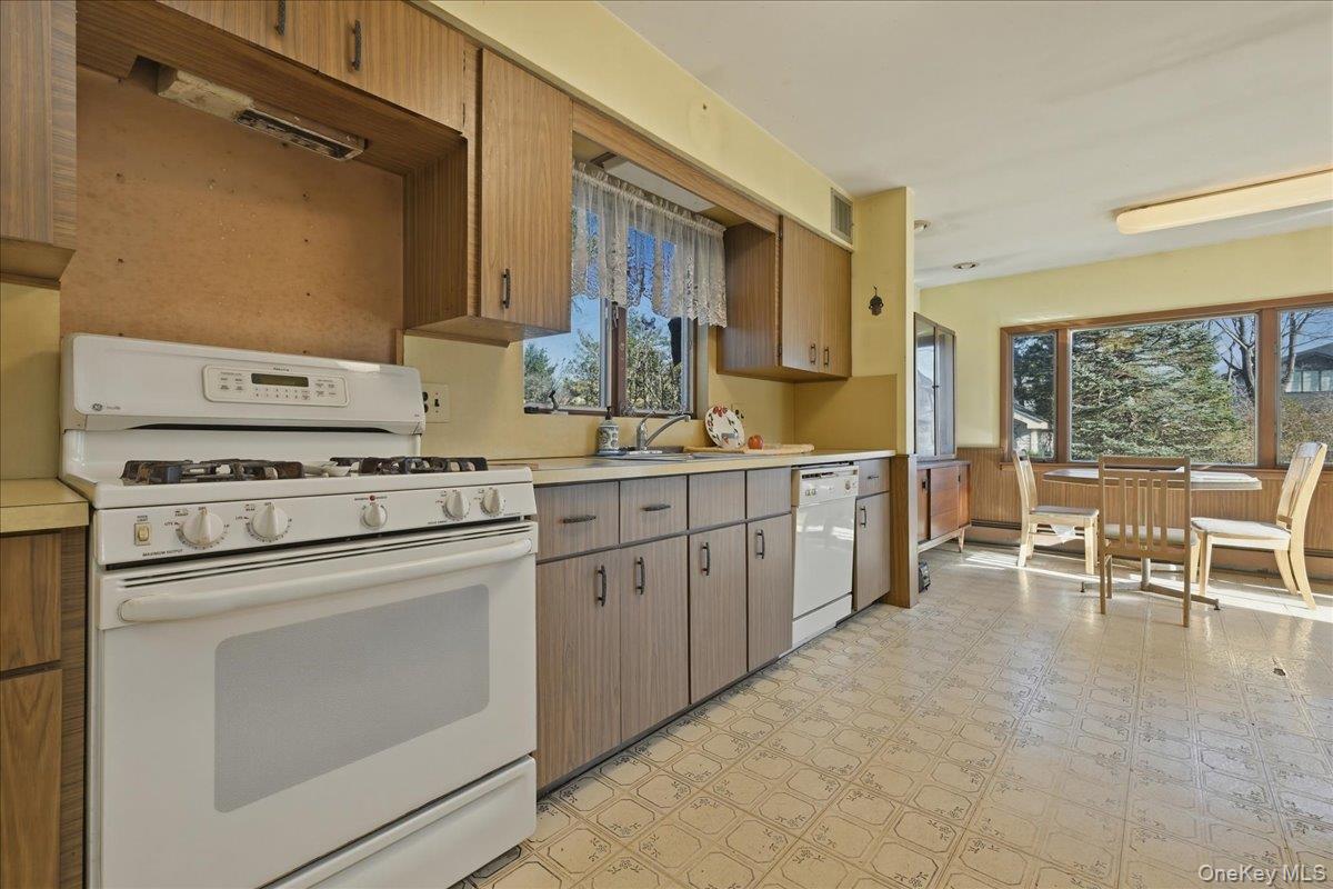 590 Waterview Road Oceanside, NY 11572 - Photo 7 of 26 a kitchen that has a lot of cabinets in it and appliances