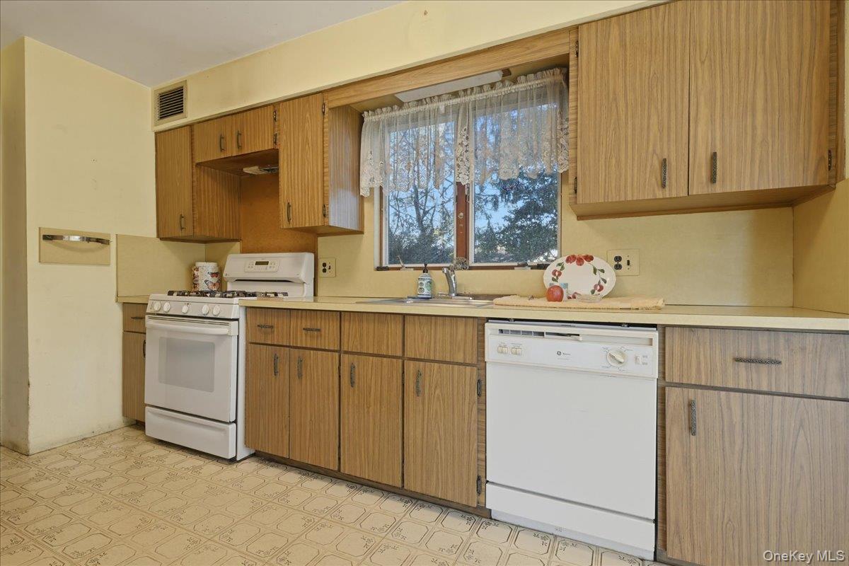 590 Waterview Road Oceanside, NY 11572 - Photo 8 of 26 a kitchen with cabinets oven and a sink