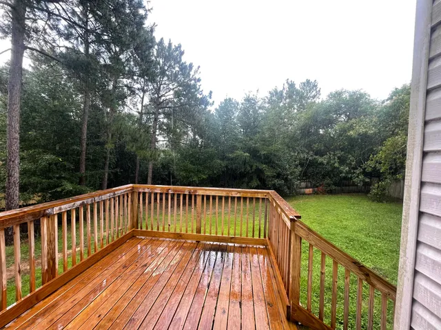 a view of balcony with wooden floor and fence