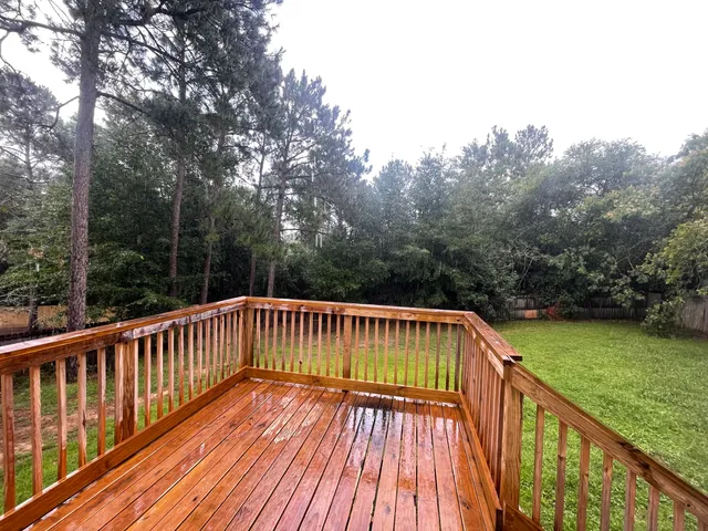 a view of balcony with wooden floor and fence
