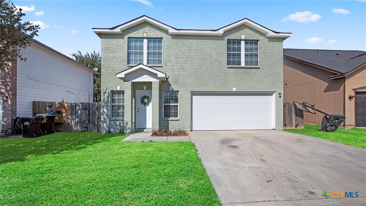 8619 Key N Way Converse, TX 78109 - Photo 1 of 1 a front view of a house with a yard and garage