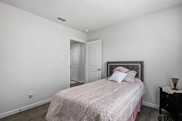a bedroom with a bed and a night stand