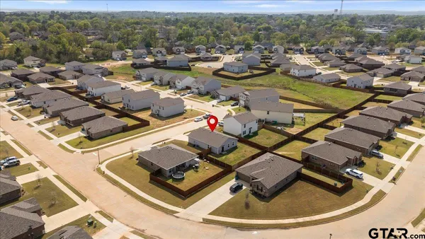 an aerial view of a house with a swimming pool