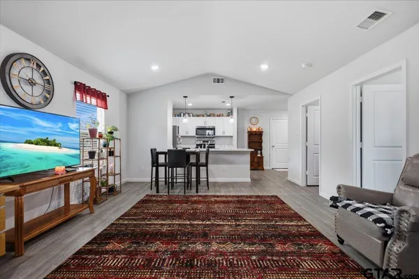 a room with lots of wooden furniture and a rug