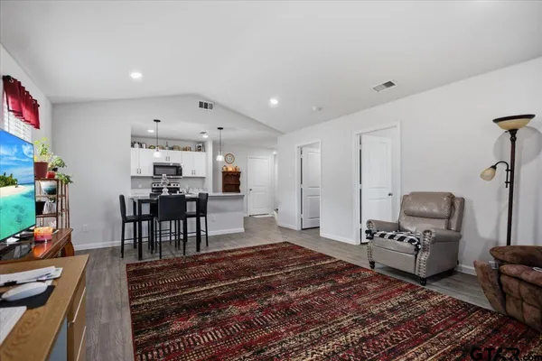a living room with furniture and a rug
