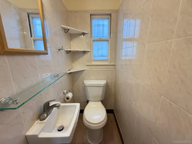 a white toilet sitting next to a bathroom sink