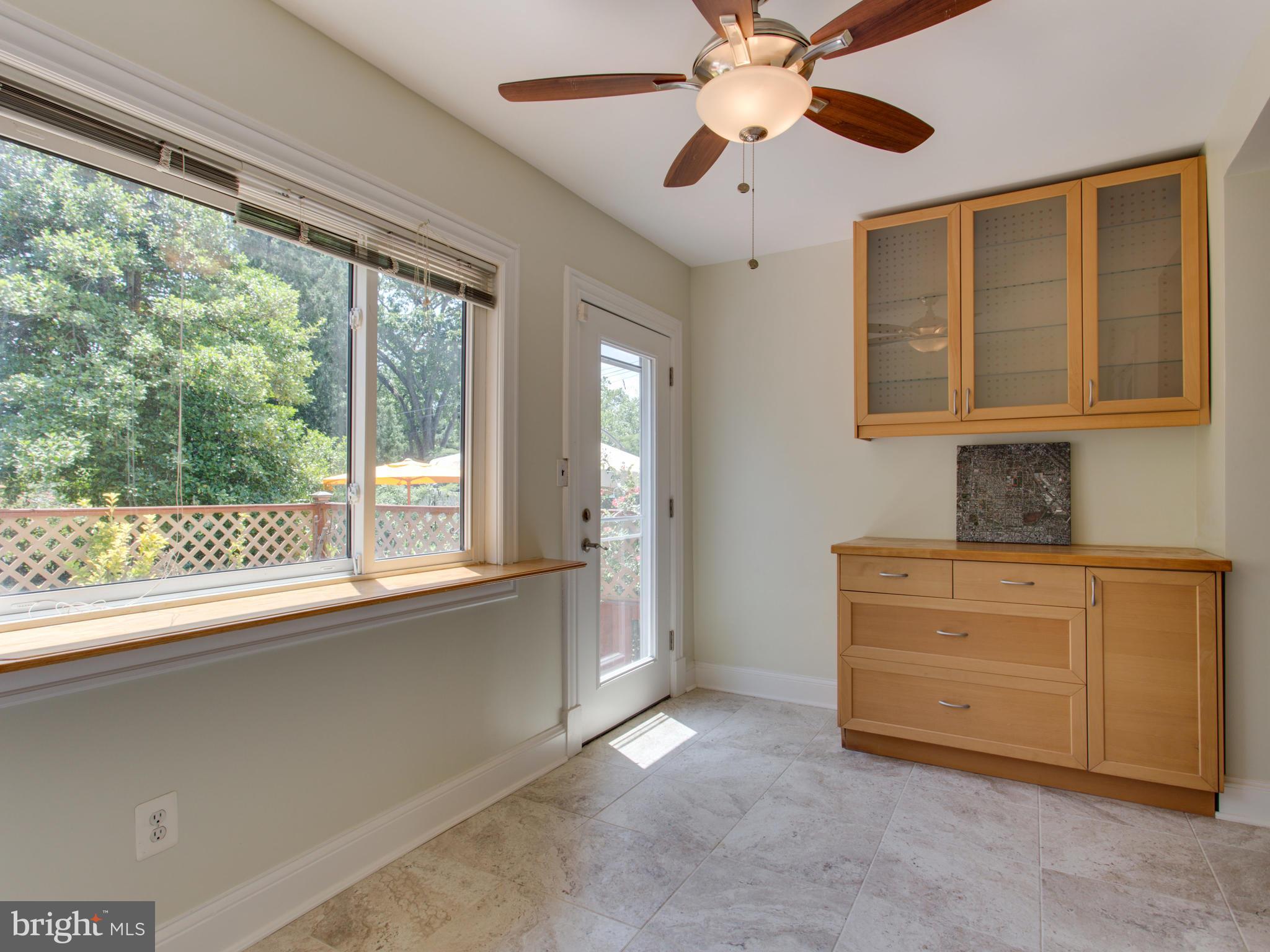408 Rittenhouse Street Northwest Washington, DC 20011 - Photo 11 of 30 a kitchen with a window wooden floor and a ceiling fan