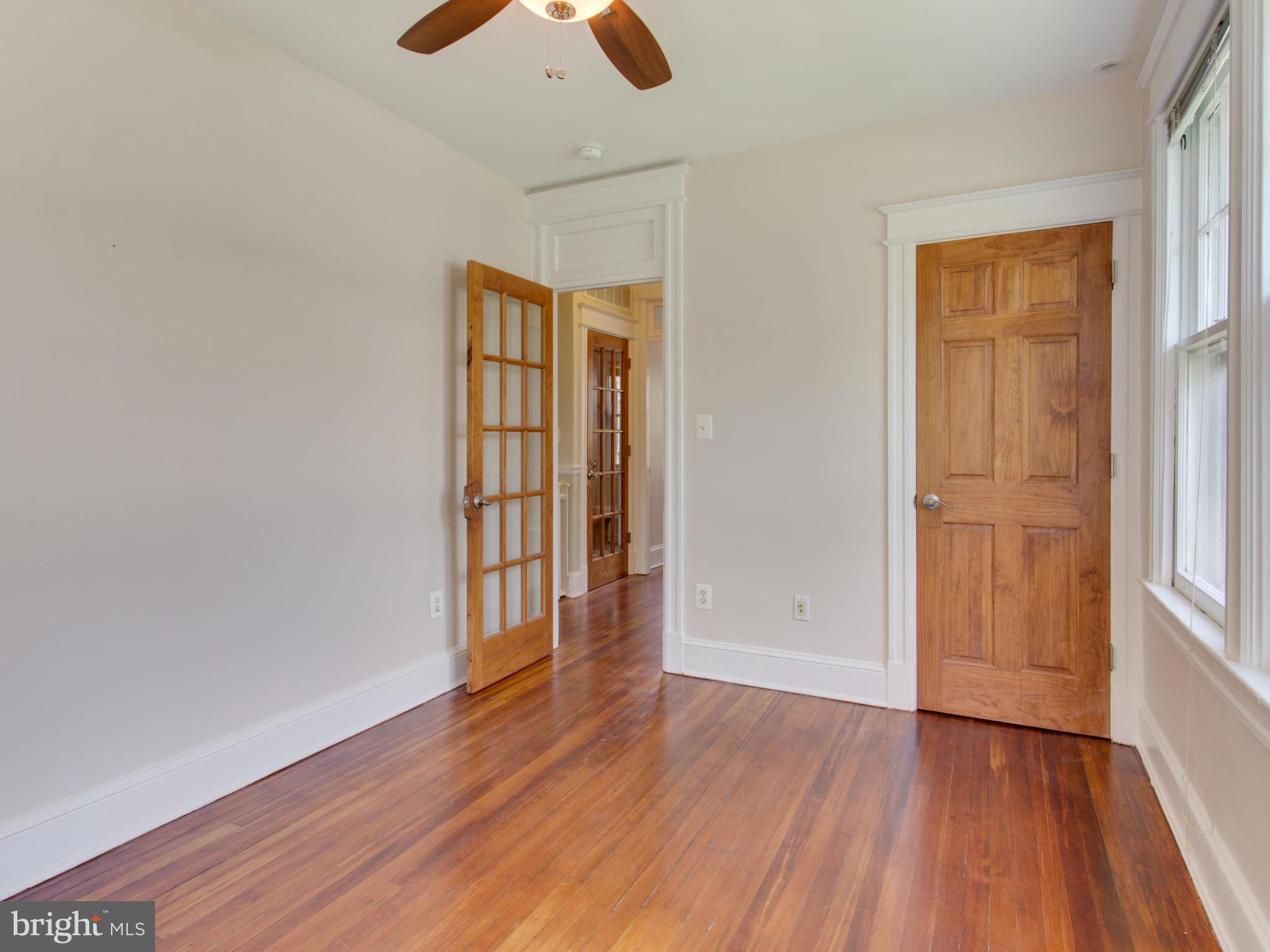 408 Rittenhouse Street Northwest Washington, DC 20011 - Photo 14 of 30 an empty room with wooden floor and windows