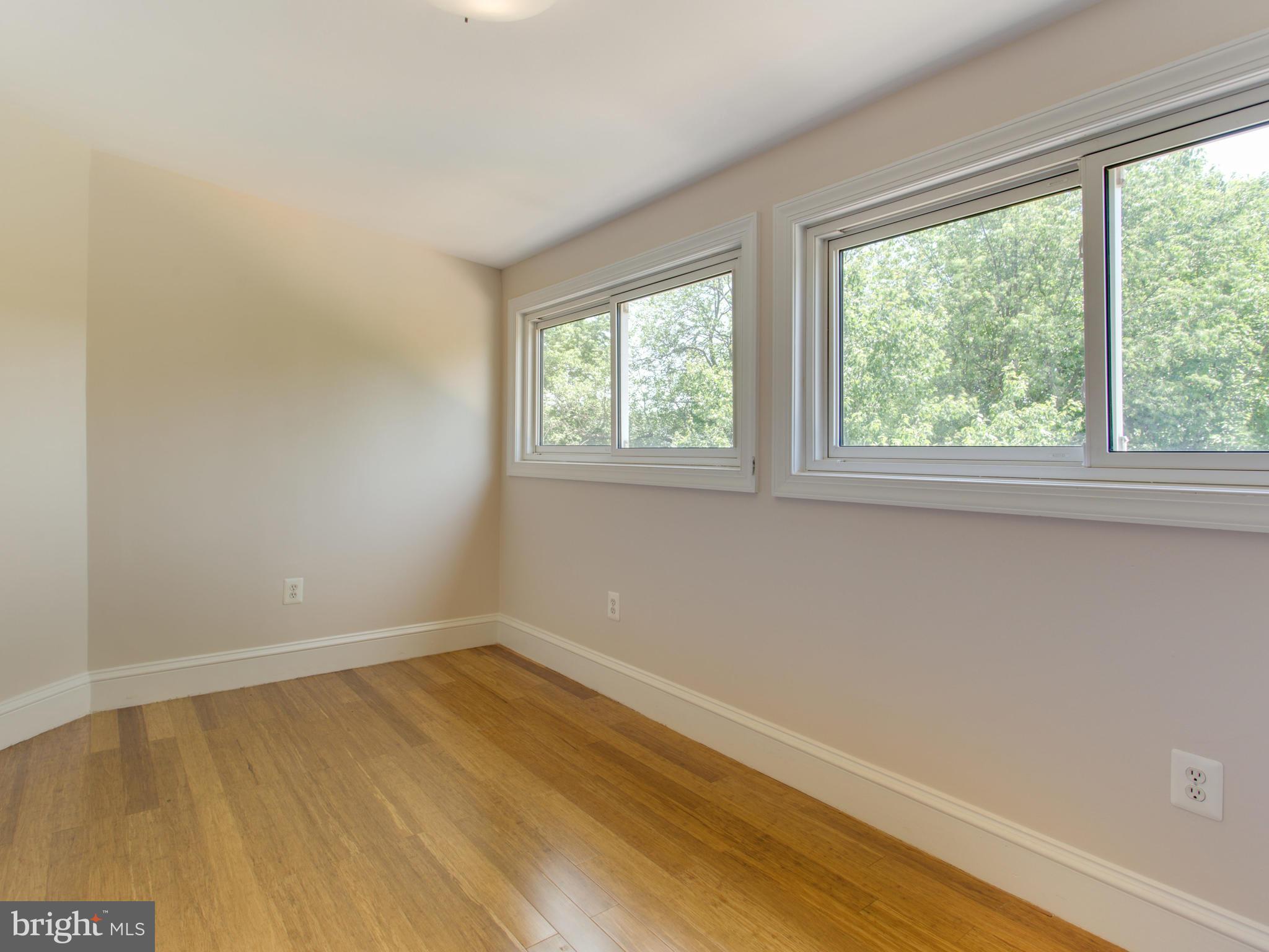 408 Rittenhouse Street Northwest Washington, DC 20011 - Photo 16 of 30 an empty room with wooden floor and windows
