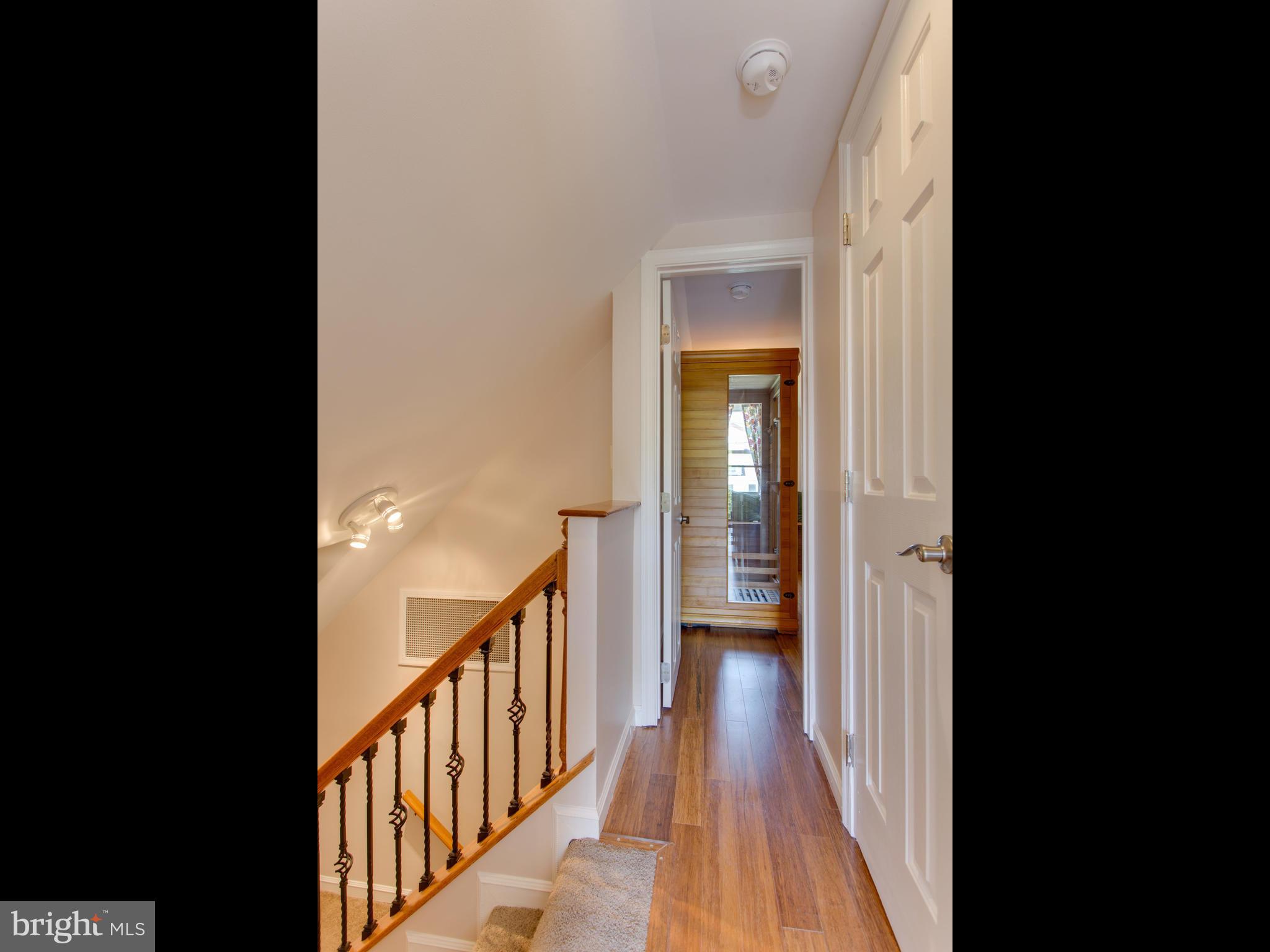 408 Rittenhouse Street Northwest Washington, DC 20011 - Photo 18 of 30 a view of a hallway with wooden floor and a living room
