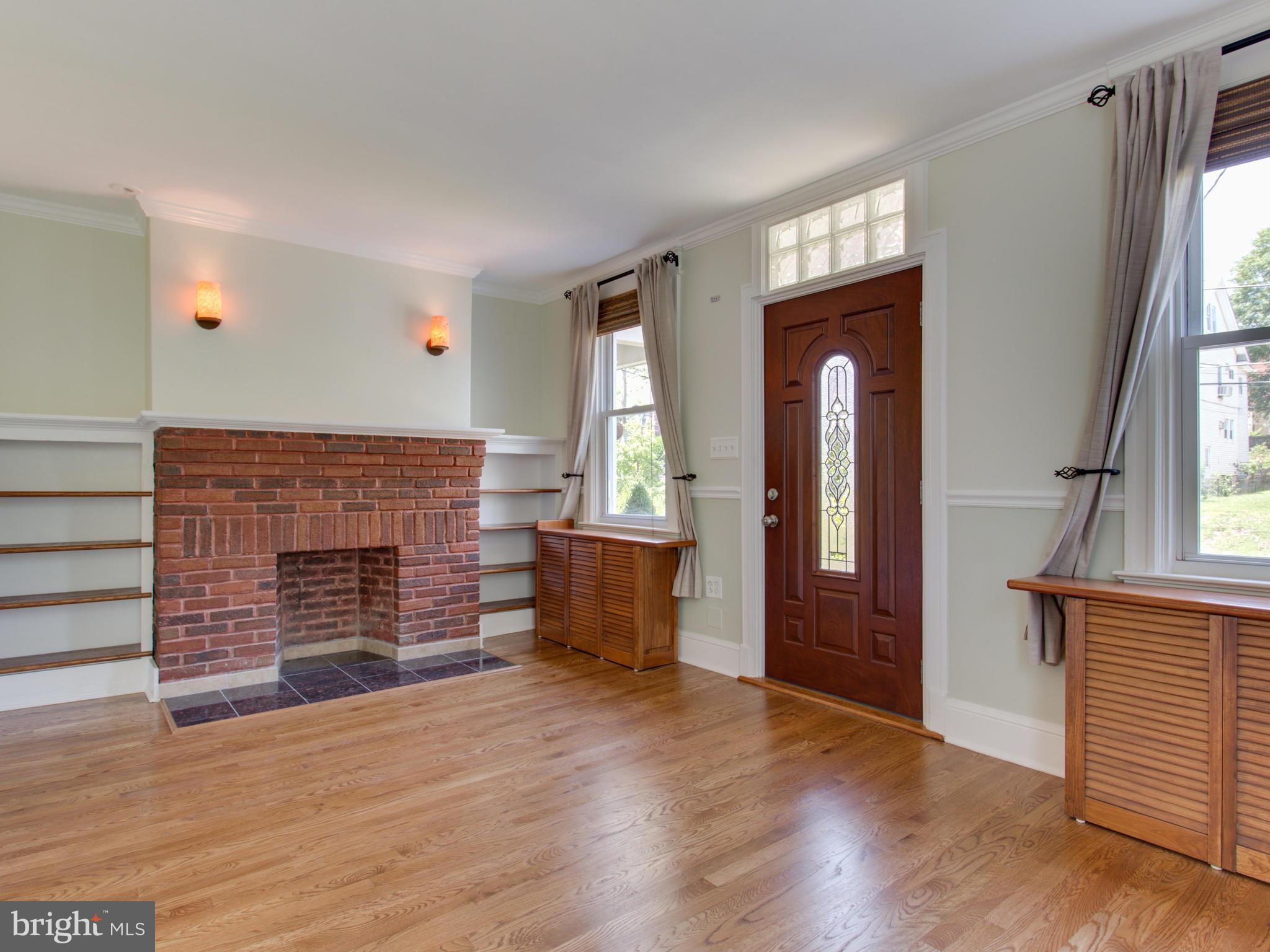 408 Rittenhouse Street Northwest Washington, DC 20011 - Photo 4 of 30 wooden floor fireplace and windows in an empty room