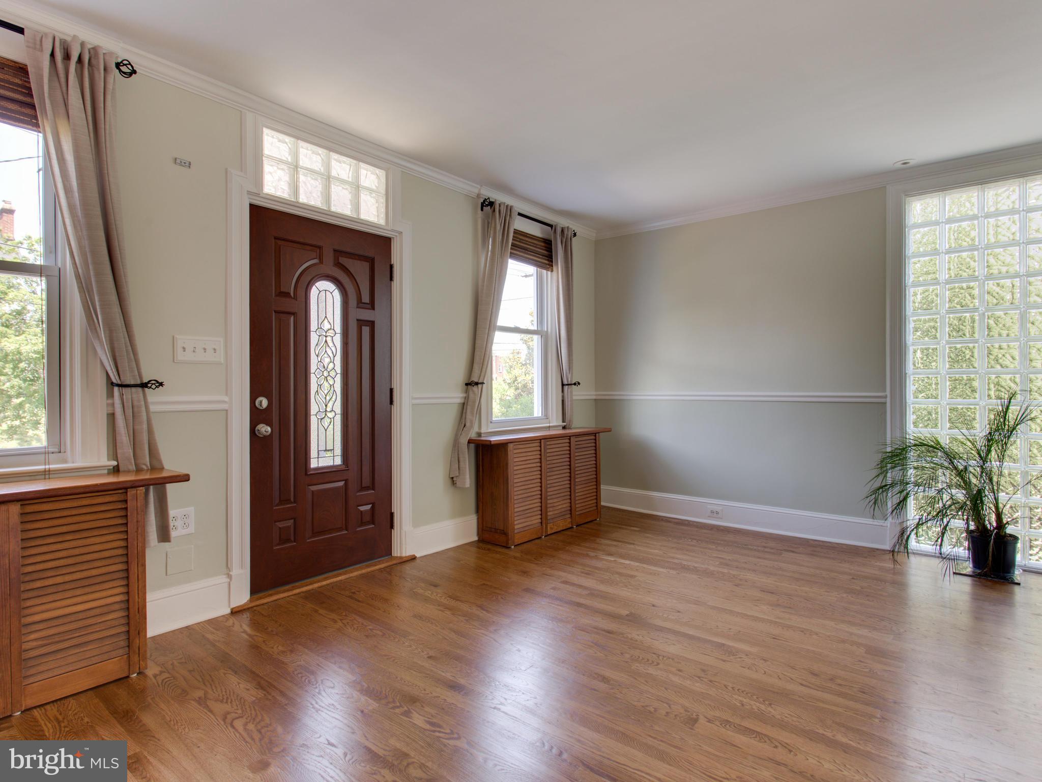 408 Rittenhouse Street Northwest Washington, DC 20011 - Photo 5 of 30 an empty room with wooden floor and windows
