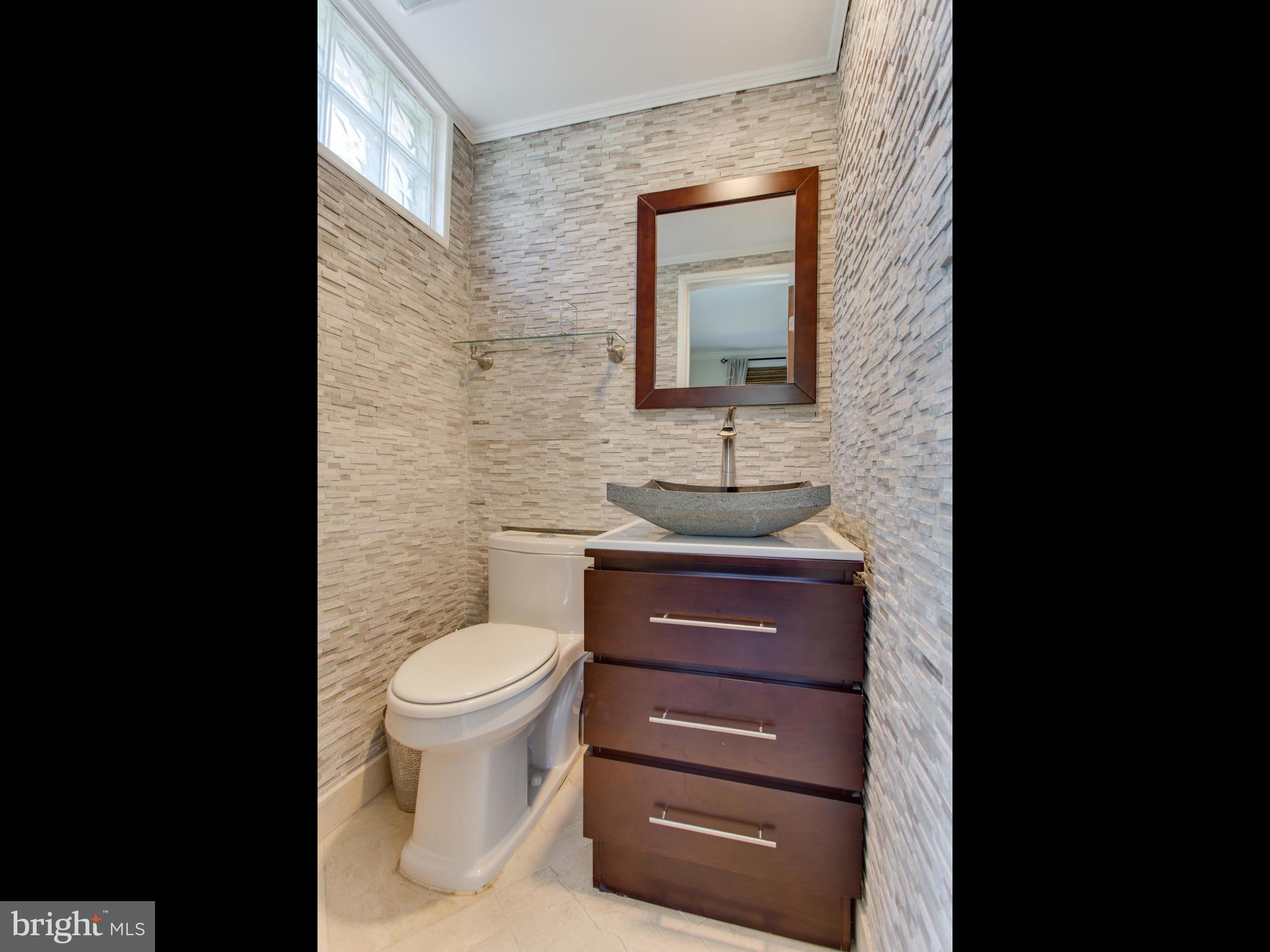 408 Rittenhouse Street Northwest Washington, DC 20011 - Photo 6 of 30 a bathroom with a toilet sink and mirror