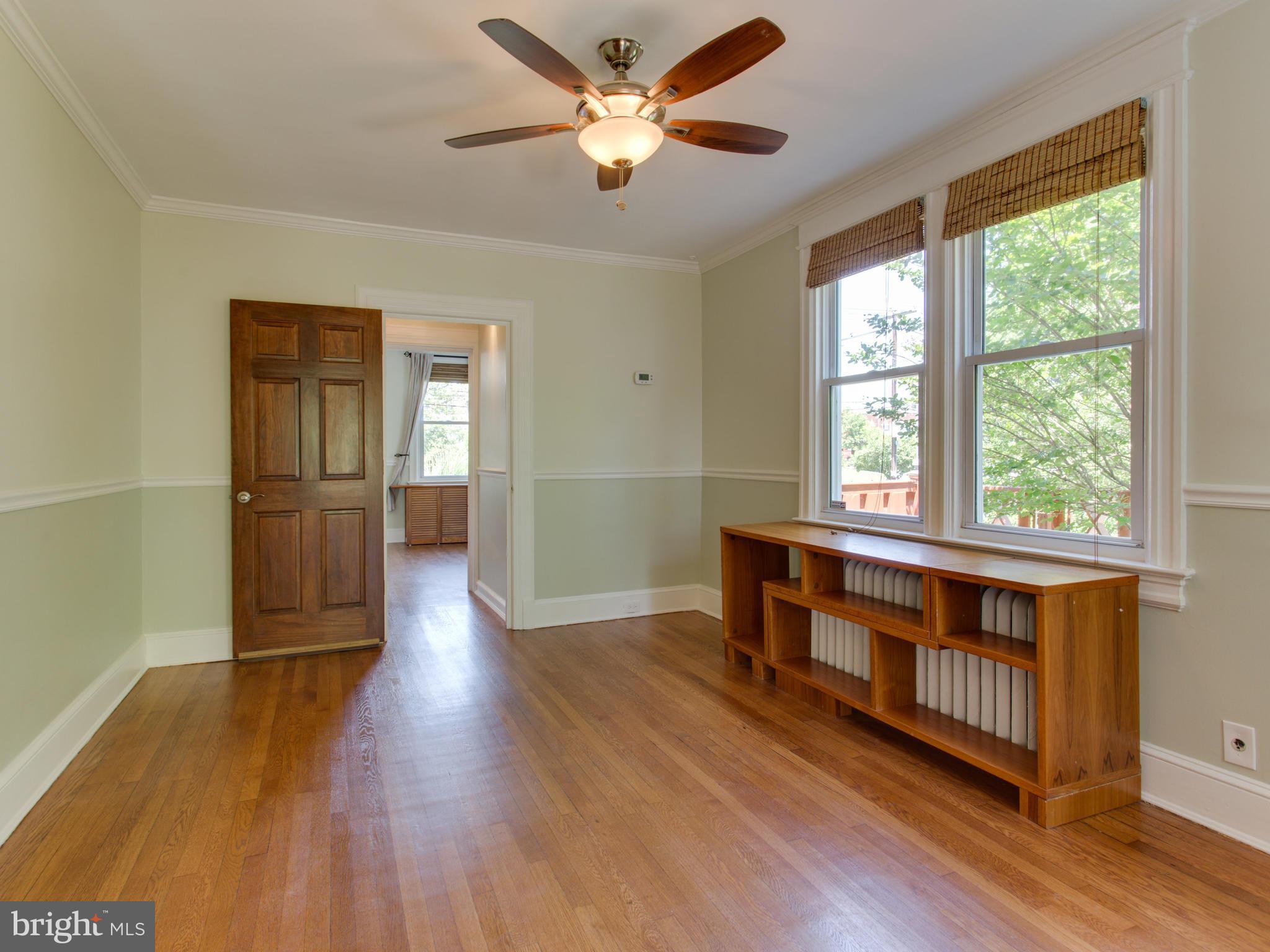 408 Rittenhouse Street Northwest Washington, DC 20011 - Photo 7 of 30 an empty room with wooden floor a ceiling fan and windows