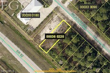 542 Meadow Road Lehigh Acres, FL 33973 - Photo 1 of 1 a sign broad on a street