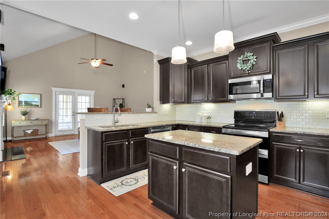 43 Shellnut Circle Spring Lake, NC 28390 - Photo 14 of 35 a kitchen with a sink stove and cabinets