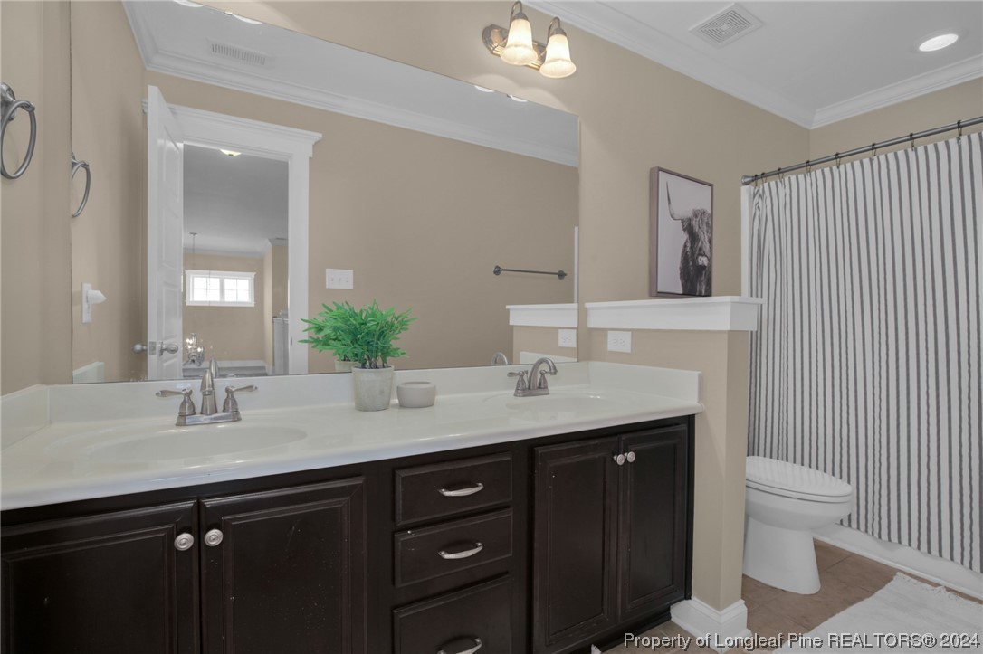 43 Shellnut Circle Spring Lake, NC 28390 - Photo 24 of 35 a bathroom with a granite countertop sink a toilet and a mirror