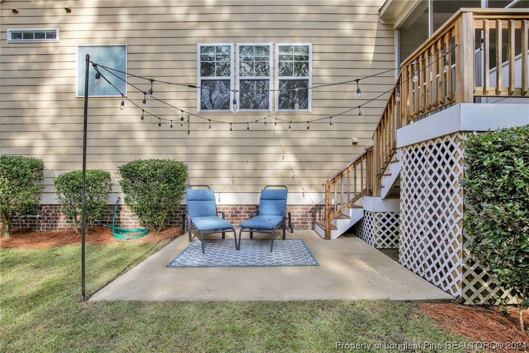 43 Shellnut Circle Spring Lake, NC 28390 - Photo 30 of 35 a view of a patio with table and chairs with wooden floor and fence