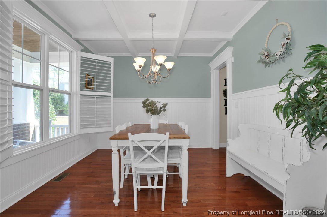 43 Shellnut Circle Spring Lake, NC 28390 - Photo 7 of 35 a dining room with furniture potted plants and wooden floor