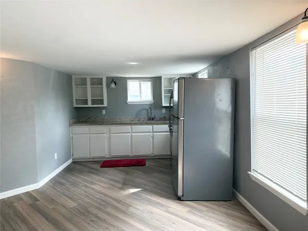 a kitchen with refrigerator and window