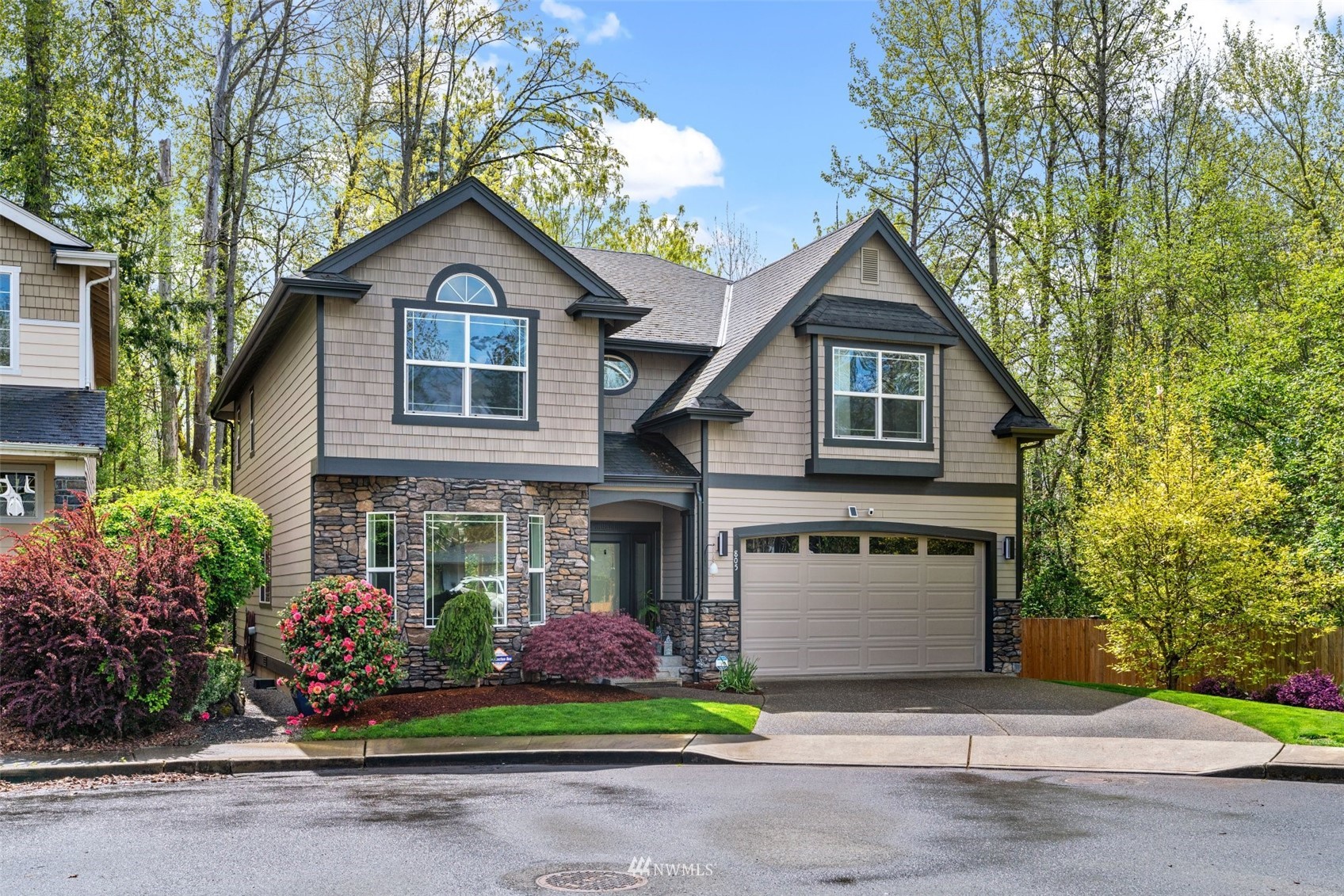 a front view of a house with a yard and garage