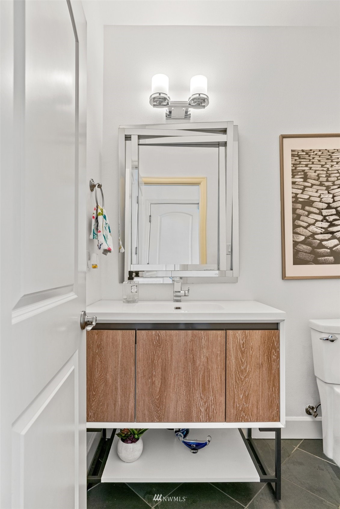 805 South 34th Place Renton, WA 98055 - Photo 16 of 36 a bathroom with a sink a toilet and mirror
