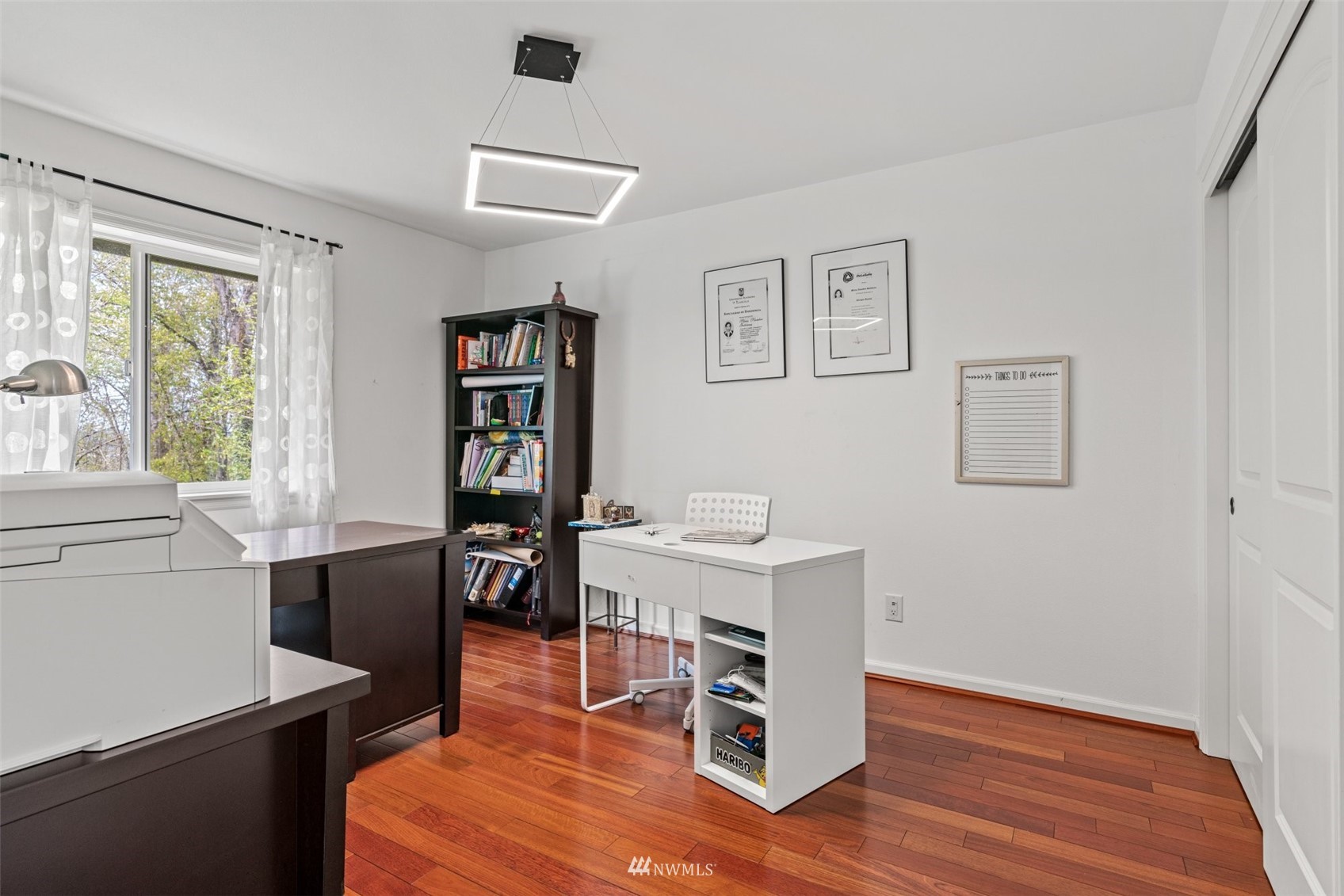 805 South 34th Place Renton, WA 98055 - Photo 20 of 36 a room with furniture a desk and a book shelf