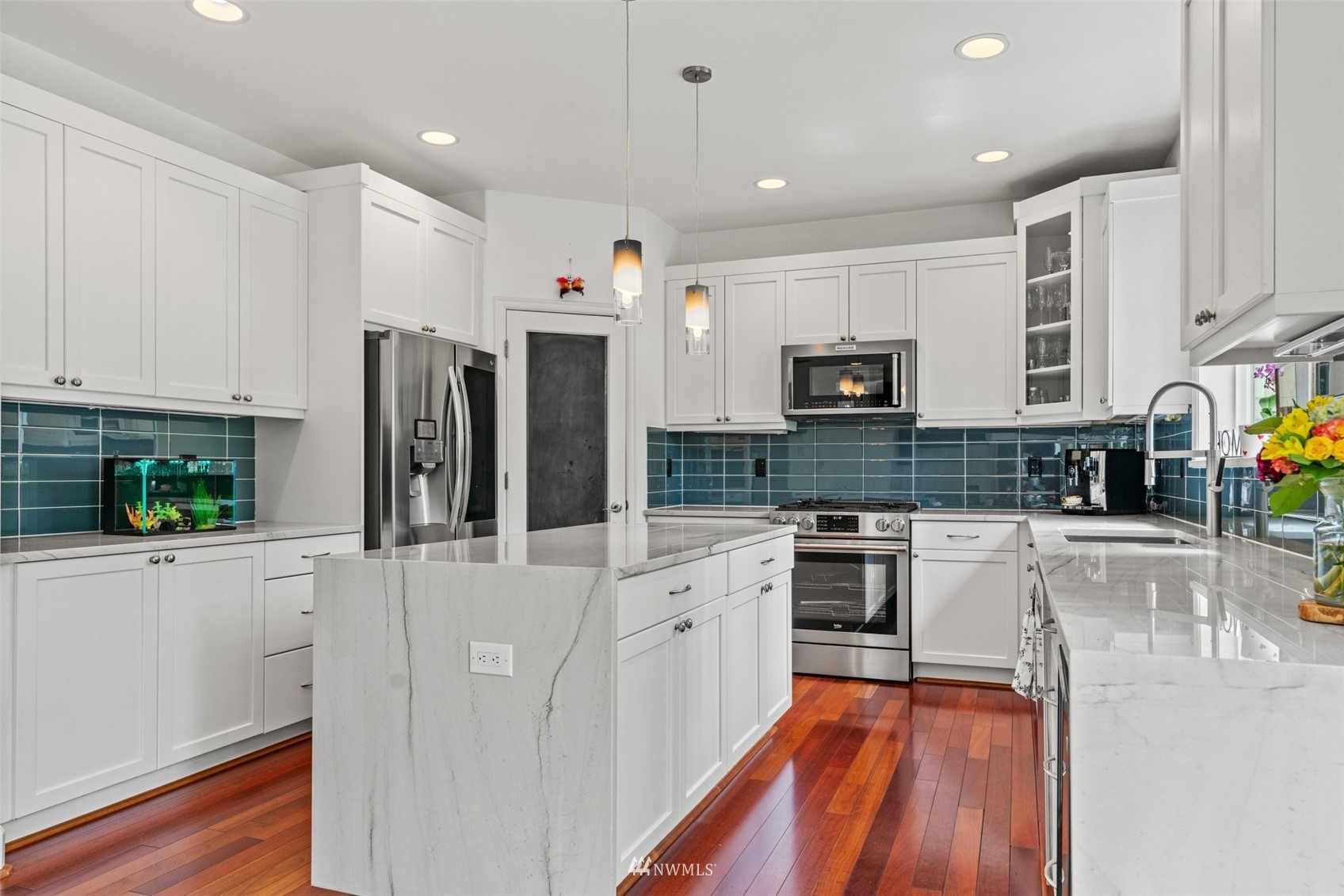 805 South 34th Place Renton, WA 98055 - Photo 10 of 36 a large kitchen with stainless steel appliances granite countertop a stove a sink and a refrigerator